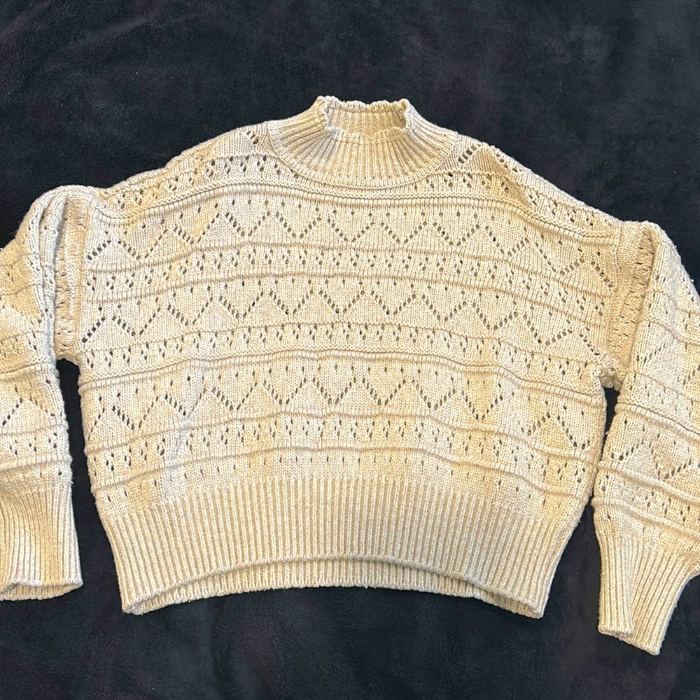Knitted cream winter sweater.